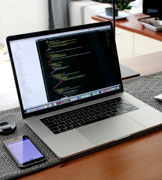 macbook pro on brown wooden table